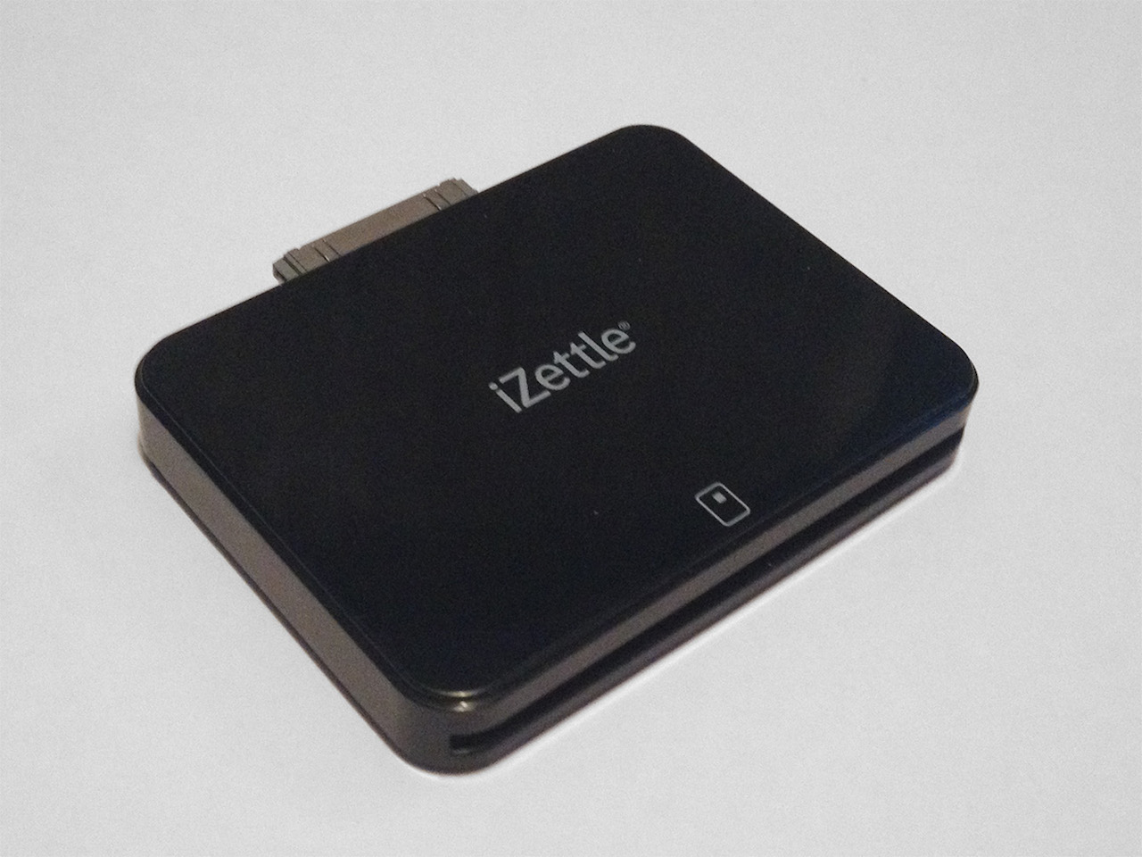 The iZettle device. It's a black rectangle with an iPhone connector on one side and a slot for a card on the other.