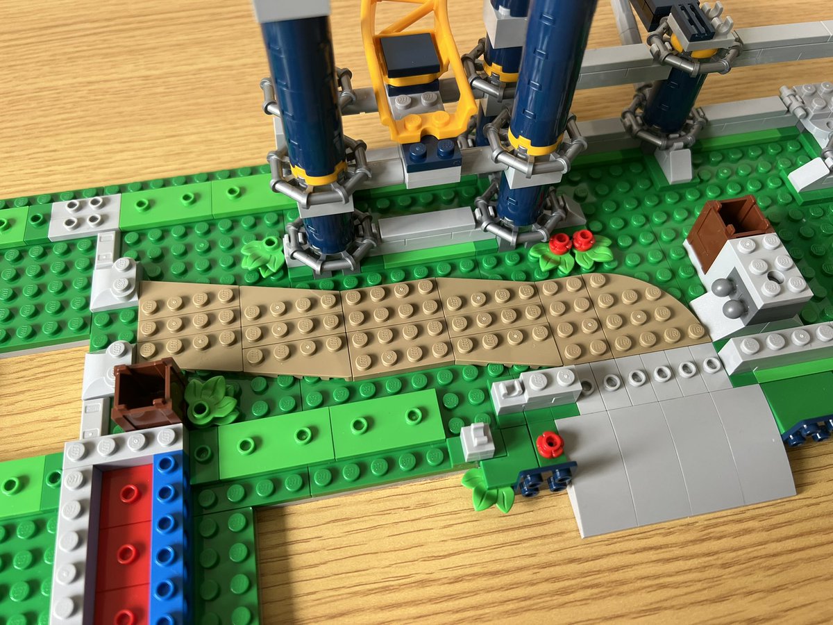 A lego structure with a flat pale brown section on the floor. It’s four studs wide and zig zags a little bit.