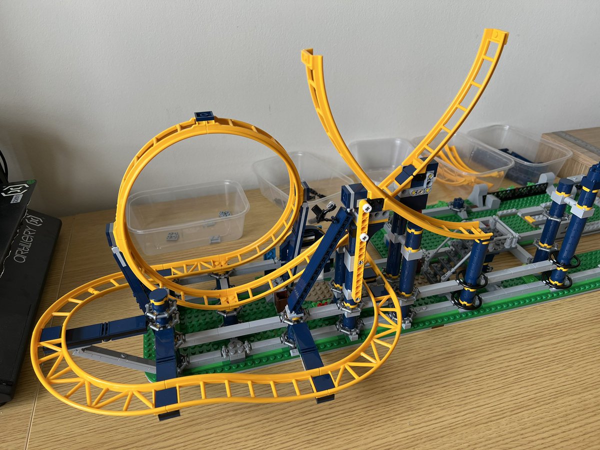 A lego roller coaster with one small loop and a half finished bigger loop